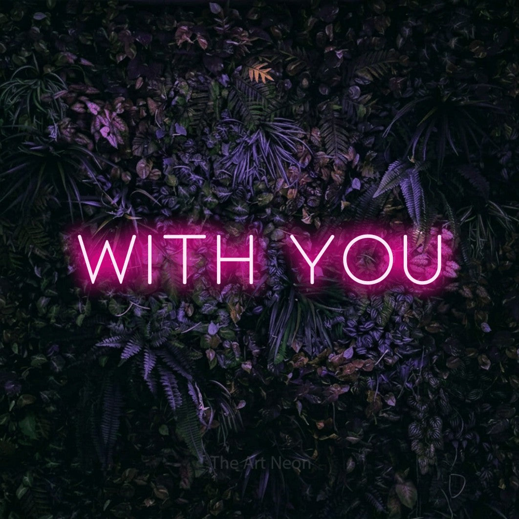 Hot pink LED neon sign reading "With You" against a purple floral wall