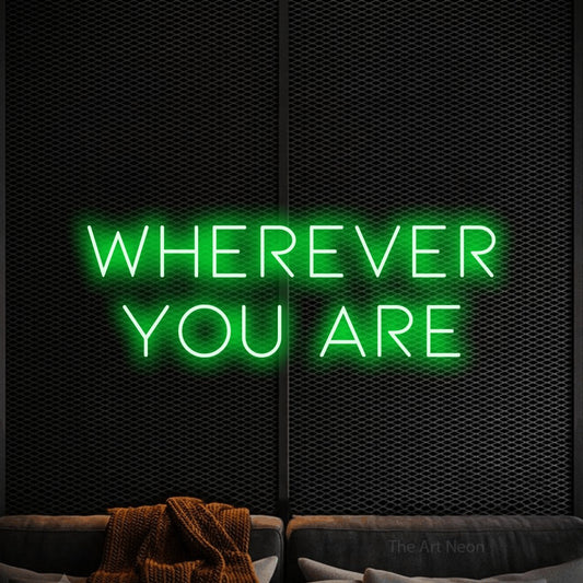 Green LED neon sign reading "Wherever You Are" against a black textured wall