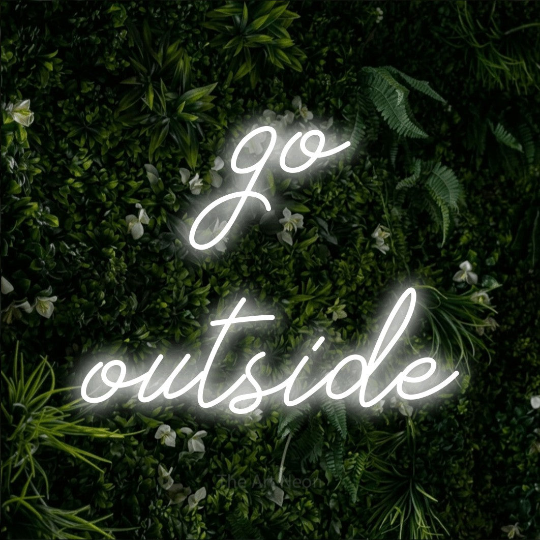 Cool white script-style LED neon sign reading "Go Outside" against a leafy green wall