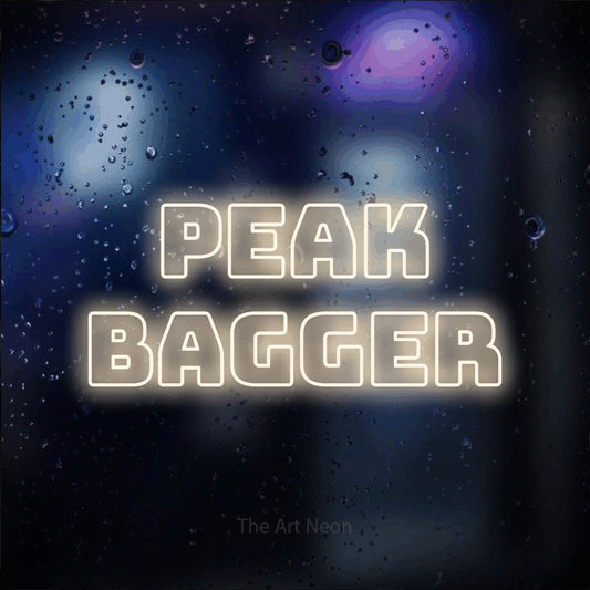 Warm white outline-style LED neon sign reading "Peak Bagger" against a dark blue bokeh background