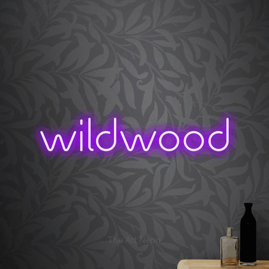 Purple LED neon sign reading "Wildwood" against light grey floral wallpaper