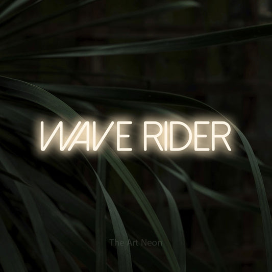 Warm white LED neon sign reading "Wave Rider" against dark tropical leaves