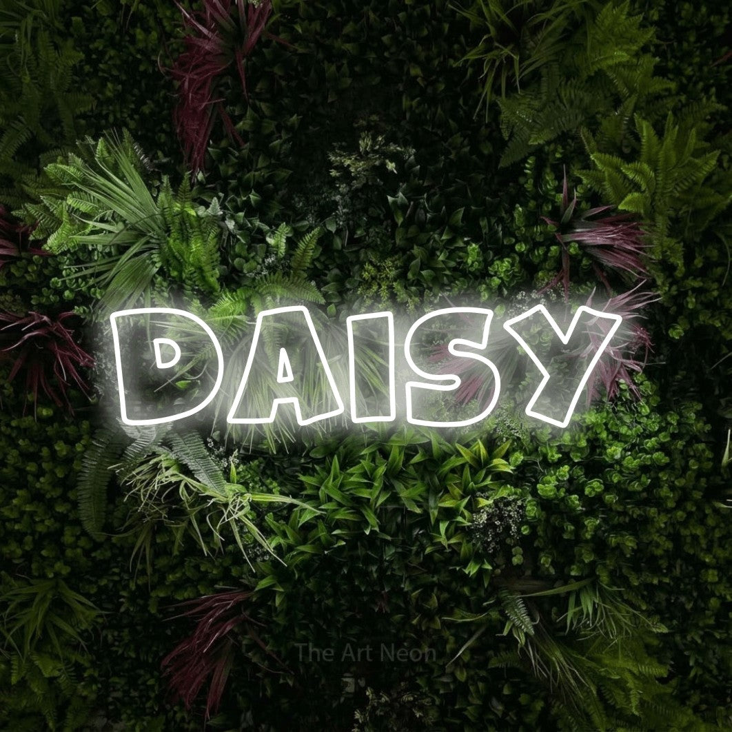 Cool white outline-style LED neon sign reading "Daisy" against a lush garden wall with pink flowers