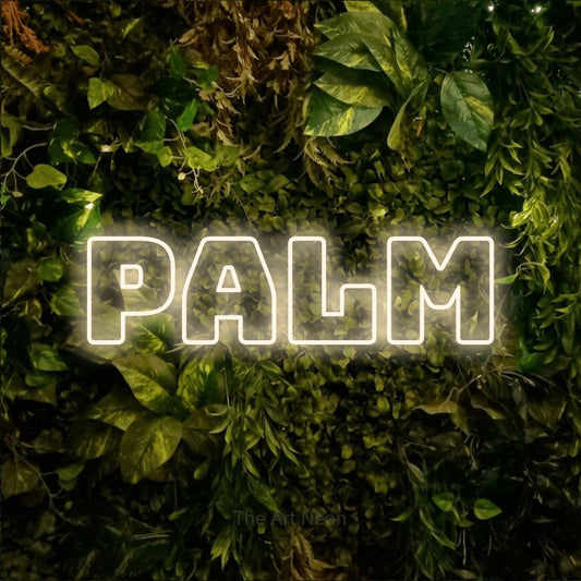 Warm white outline-style LED neon sign reading "Palm" against a textured moss and foliage wall