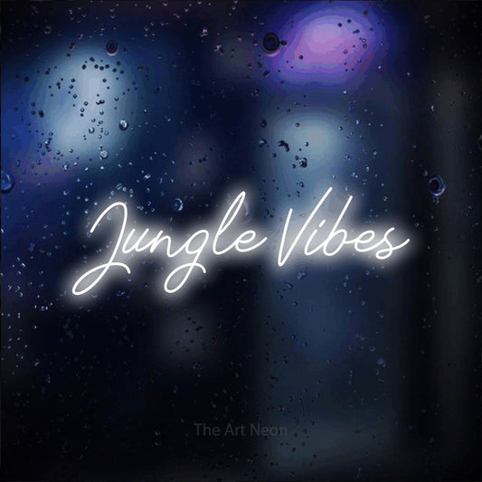 Cool white script-style LED neon sign reading "Jungle Vibes" against a dark blue bokeh background
