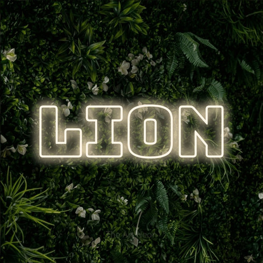 Warm white outline-style LED neon sign reading "Lion" against a leafy green wall