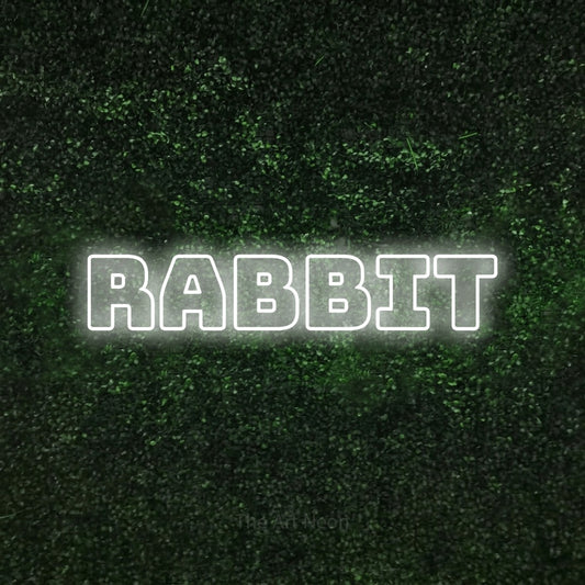 Cool white outline-style LED neon sign reading "Rabbit" against a textured green moss wall