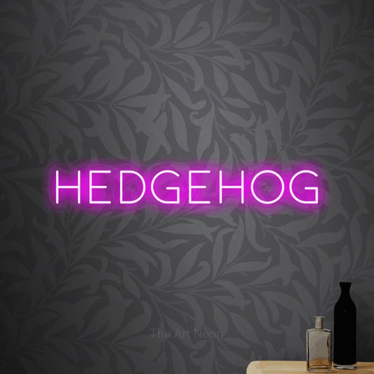 Pink LED neon sign reading "Hedgehog" against light grey floral wallpaper