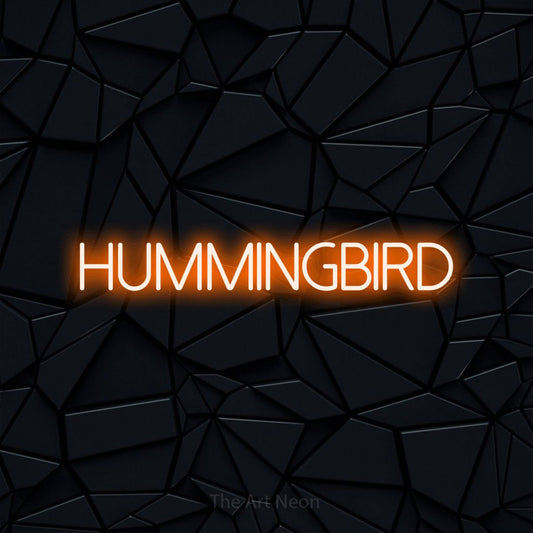 Orange LED neon sign reading "Hummingbird" against a black faceted wall