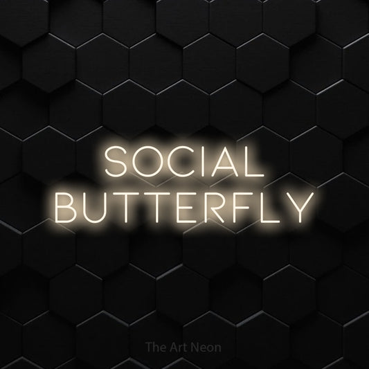Warm white LED neon sign reading "Social Butterfly" against a black hexagonal wall