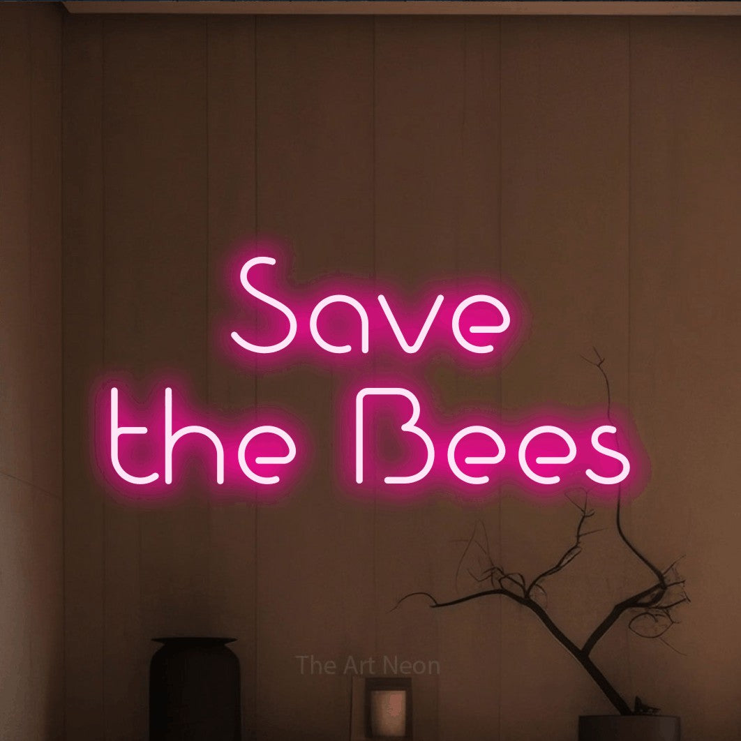 Hot pink LED neon sign reading "Save the Bees" against a warm brown wall