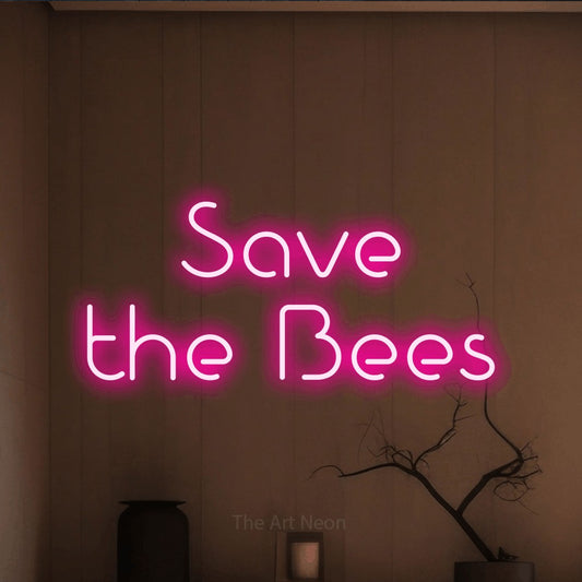 Hot pink LED neon sign reading "Save the Bees" against a warm brown wall