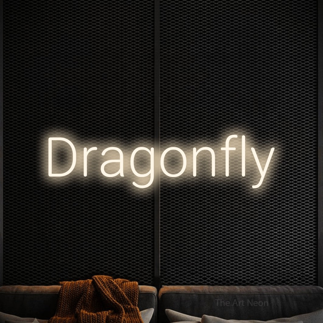 Warm white LED neon sign reading "Dragonfly" against a black textured wall