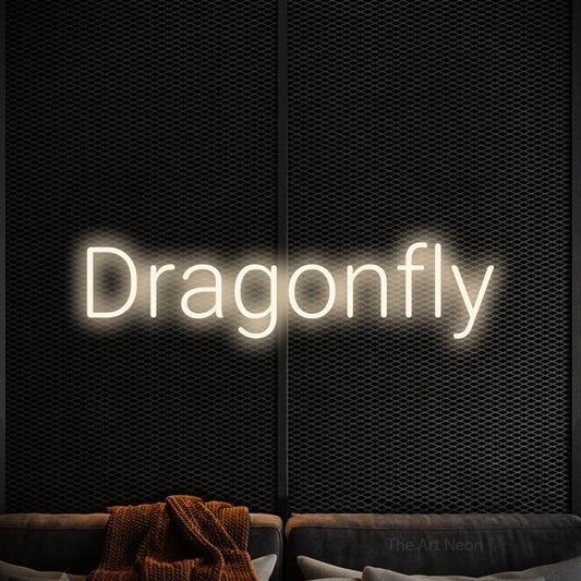 Warm white LED neon sign reading "Dragonfly" against a black textured wall