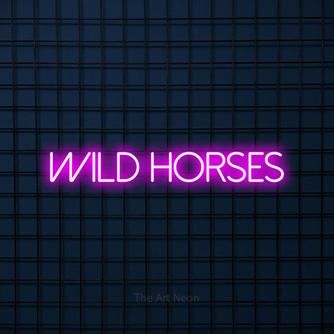 Pink LED neon sign reading "Wild Horses" against a dark blue tiled wall