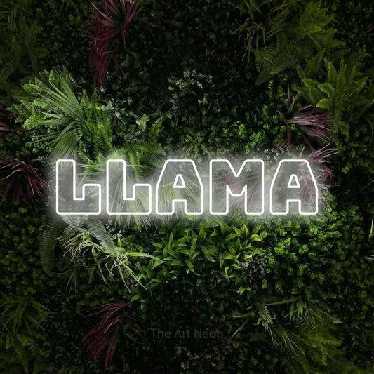 Cool white outline-style LED neon sign reading "Llama" against a lush garden wall with pink flowers