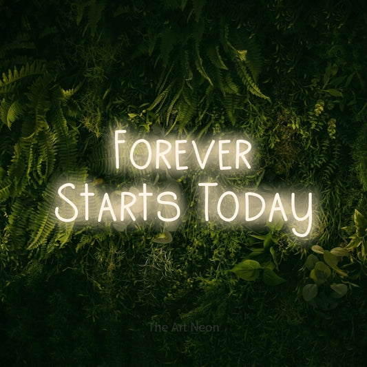 Warm white LED neon sign reading "Forever Starts Today" against a moss-covered green wall for wedding décor