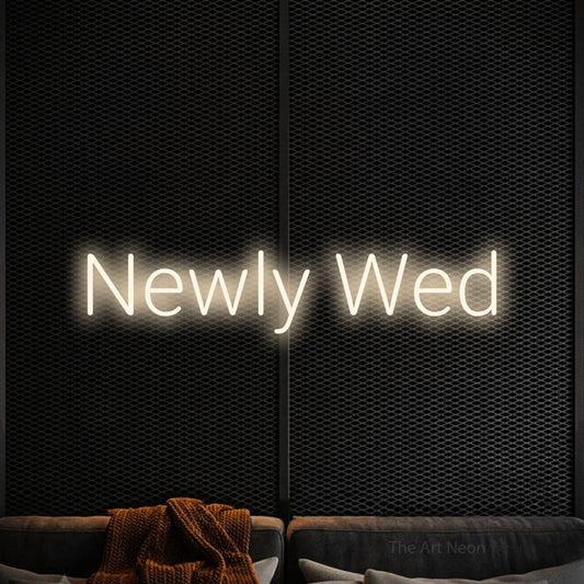 Warm white LED neon sign reading "Newly Wed" against a black textured wall for wedding décor