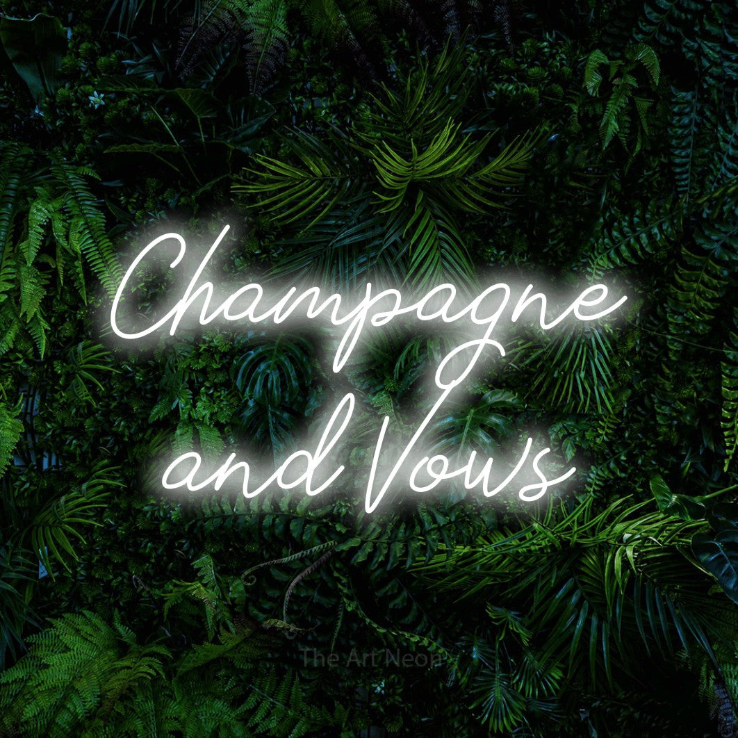 Cool white script-style LED neon sign reading "Champagne and Vows" against a dense tropical foliage wall for wedding décor
