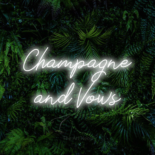 Cool white script-style LED neon sign reading "Champagne and Vows" against a dense tropical foliage wall for wedding décor