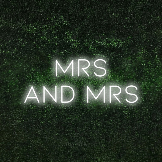 Cool white LED neon sign reading "Mrs and Mrs" against a textured green moss wall for wedding décor