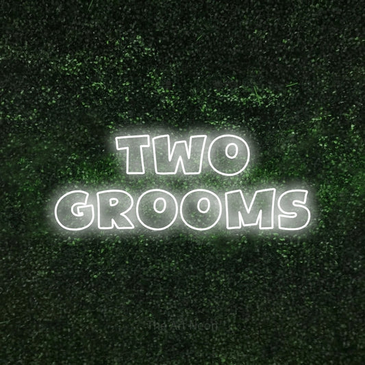 Cool white outline-style LED neon sign reading "Two Grooms" against a textured green moss wall for wedding décor