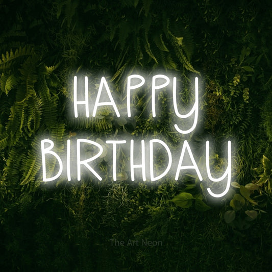 Cool white LED neon sign reading "Happy Birthday" against a moss-covered green wall for party décor