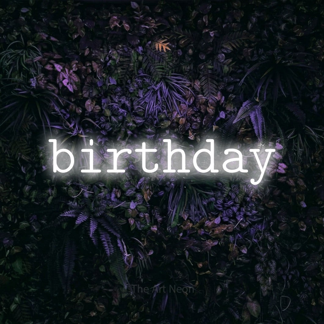Cool white LED neon sign reading "Birthday" against a purple floral wall for party décor