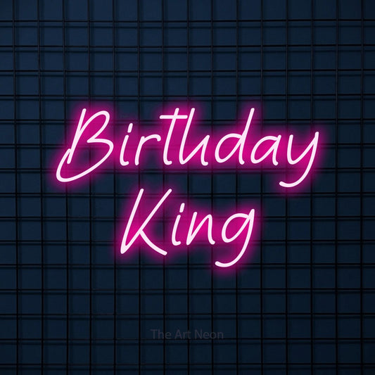Hot pink LED neon sign reading "Birthday King" against a dark blue tiled wall for party décor