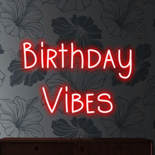 Red LED neon sign reading "Birthday Vibes" against grey floral wallpaper for party décor