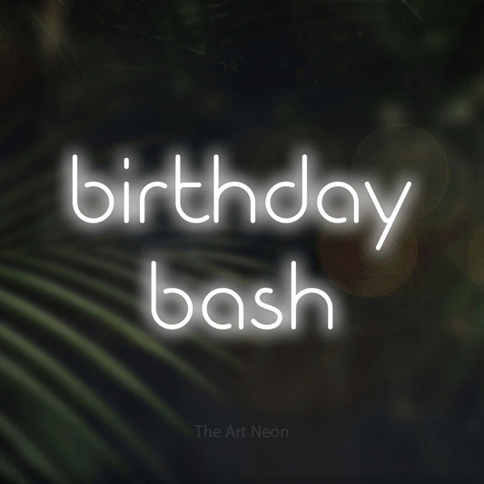 Cool white LED neon sign reading "Birthday Bash" against dark blurred palm leaves for party décor