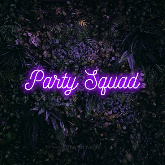 Purple script-style LED neon sign reading "Party Squad" against a purple floral wall for party décor
