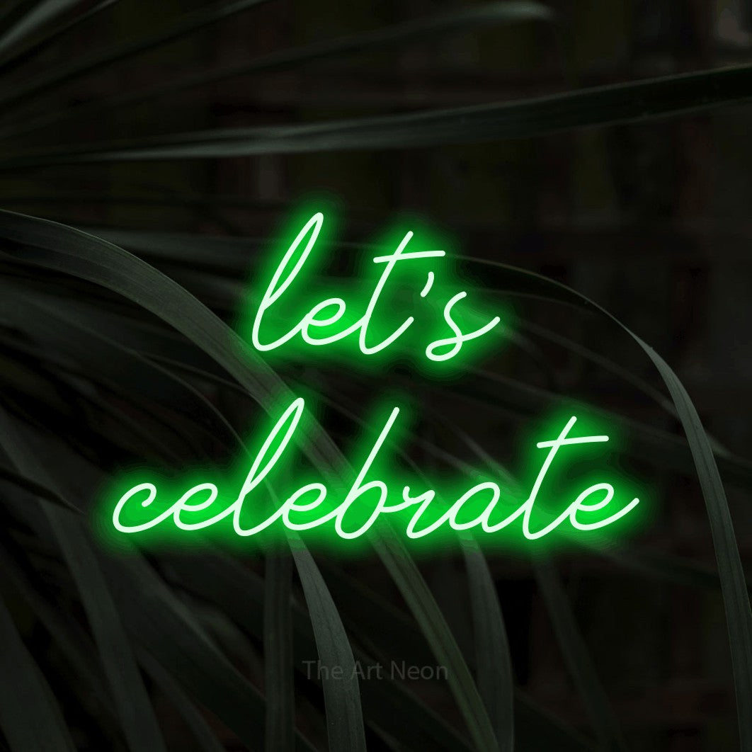 Green script-style LED neon sign reading "Let's Celebrate" against dark tropical leaves for party décor