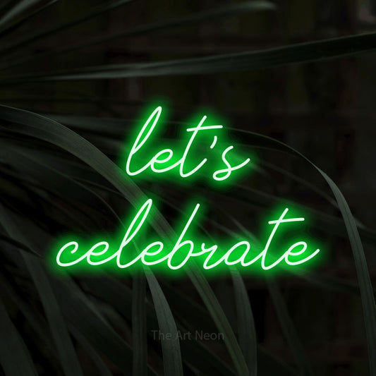 Green script-style LED neon sign reading "Let's Celebrate" against dark tropical leaves for party décor