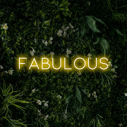 Yellow LED neon sign reading "Fabulous" against a leafy green wall for party décor