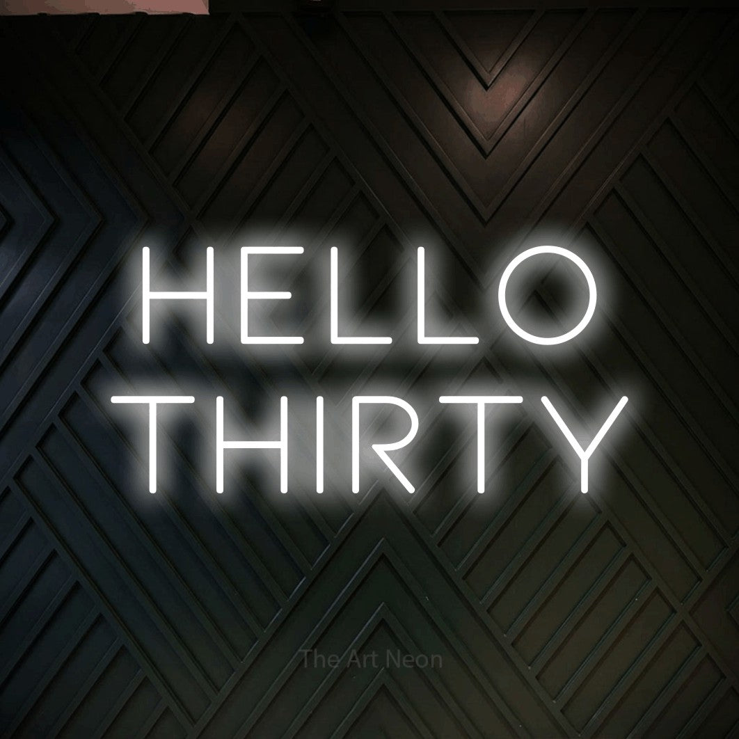Cool white LED neon sign reading "Hello Thirty" against a dark geometric wood wall for party décor