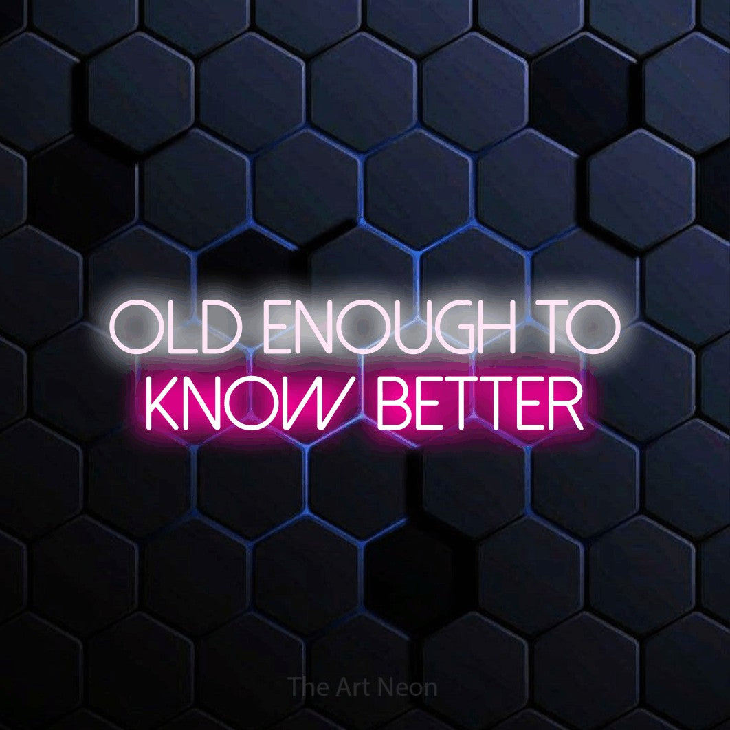 Hot pink and cool white LED neon sign reading "Old Enough to Know Better" against a blue hexagonal wall for party décor