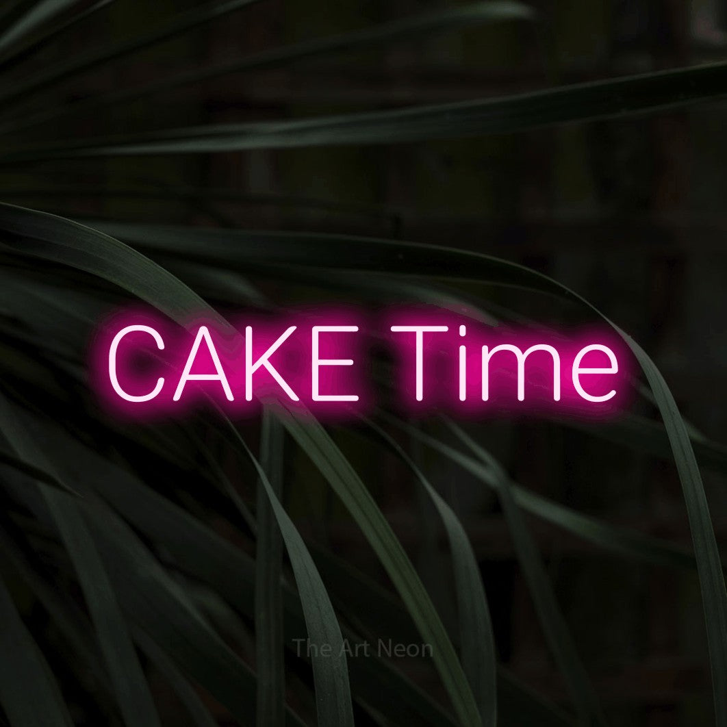 Hot pink LED neon sign reading "Cake Time" against dark tropical leaves for party décor