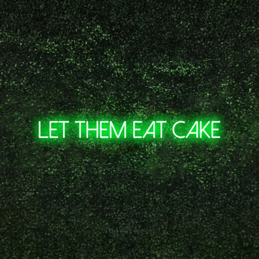 Enseigne néon à DEL à lumière verte, affichant « Let Them Eat Cake » sur un mur texturé de mousse verte, pour décorer une fête