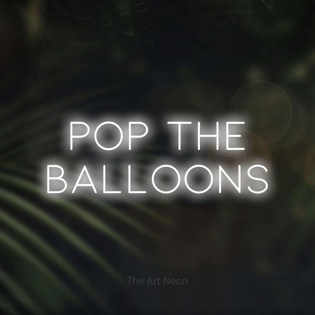 Enseigne néon à DEL à lumière blanche froide, affichant « Pop the Balloons » sur des feuilles de palmier foncées et floues, pour décorer une fête