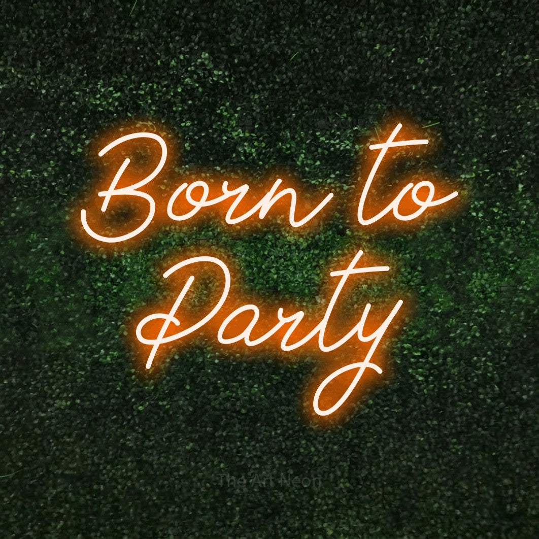 Orange script-style LED neon sign reading "Born to Party" against a textured green moss wall for party décor