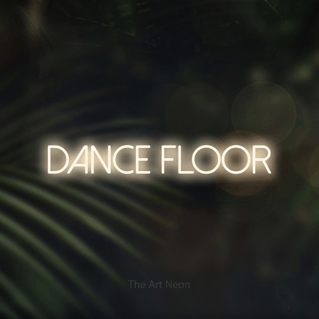 Enseigne néon à DEL à lumière blanche chaude, affichant « Dance Floor » sur des feuilles de palmier foncées et floues, pour décorer une fête