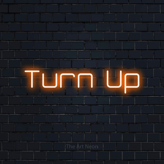 Orange LED neon sign reading "Turn Up" against a dark navy brick wall for party décor