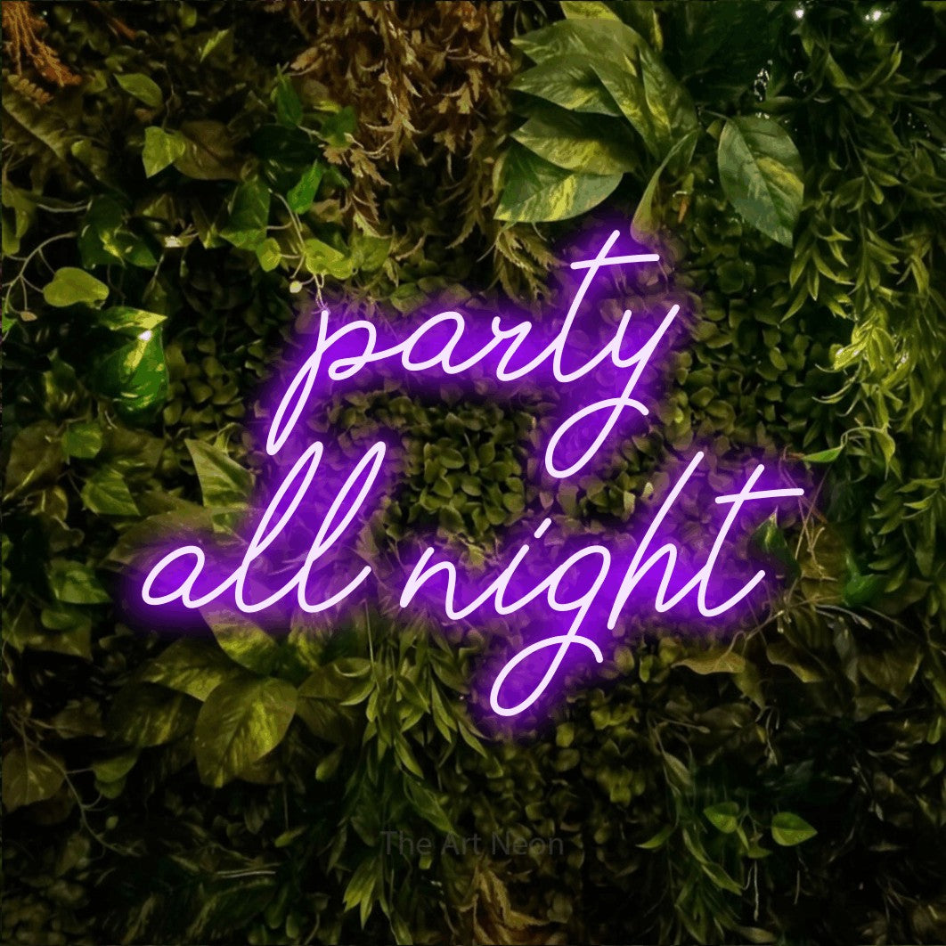Purple script-style LED neon sign reading "Party All Night" against a textured moss and foliage wall for party décor