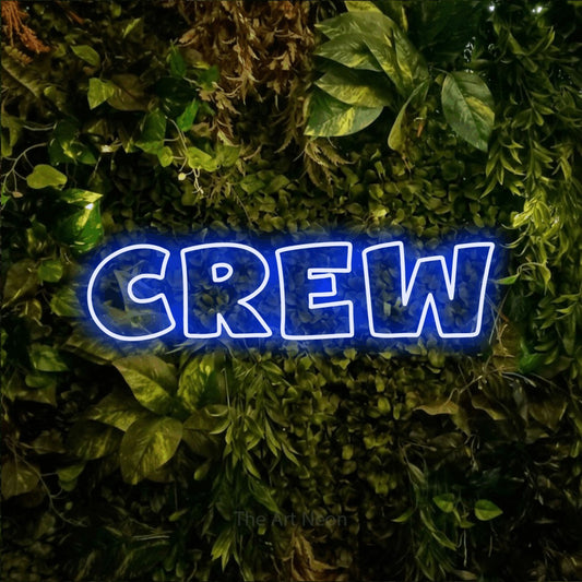 Blue outline-style LED neon sign reading "Crew" against a textured moss and foliage wall for party décor