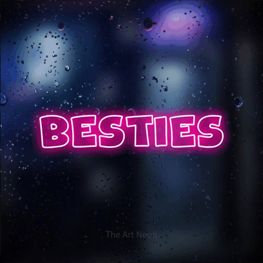 Hot pink outline-style LED neon sign reading "Besties" against a dark blue bokeh background for party décor