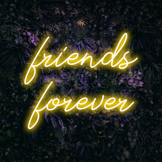 Yellow script-style LED neon sign reading "Friends Forever" against a purple floral wall for party décor