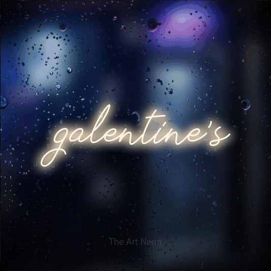 Warm white script-style LED neon sign reading "Galentine's" against a dark blue bokeh background for party décor