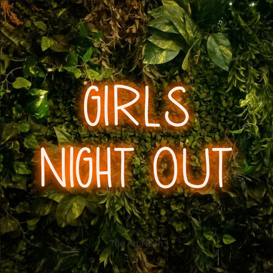 Orange LED neon sign reading "Girls Night Out" against a textured moss and foliage wall for party décor