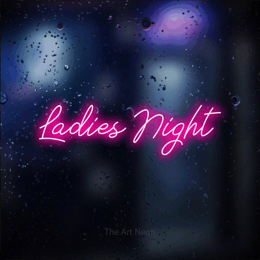 Hot pink script-style LED neon sign reading "Ladies Night" against a dark blue bokeh background for party décor